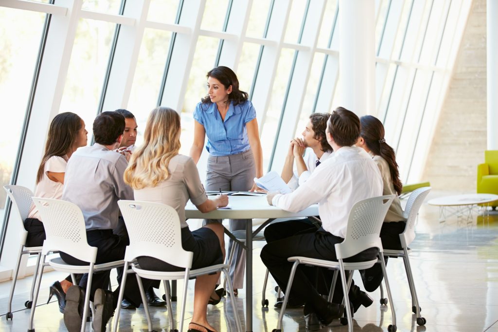 Business People Having Board Meeting In Modern Office