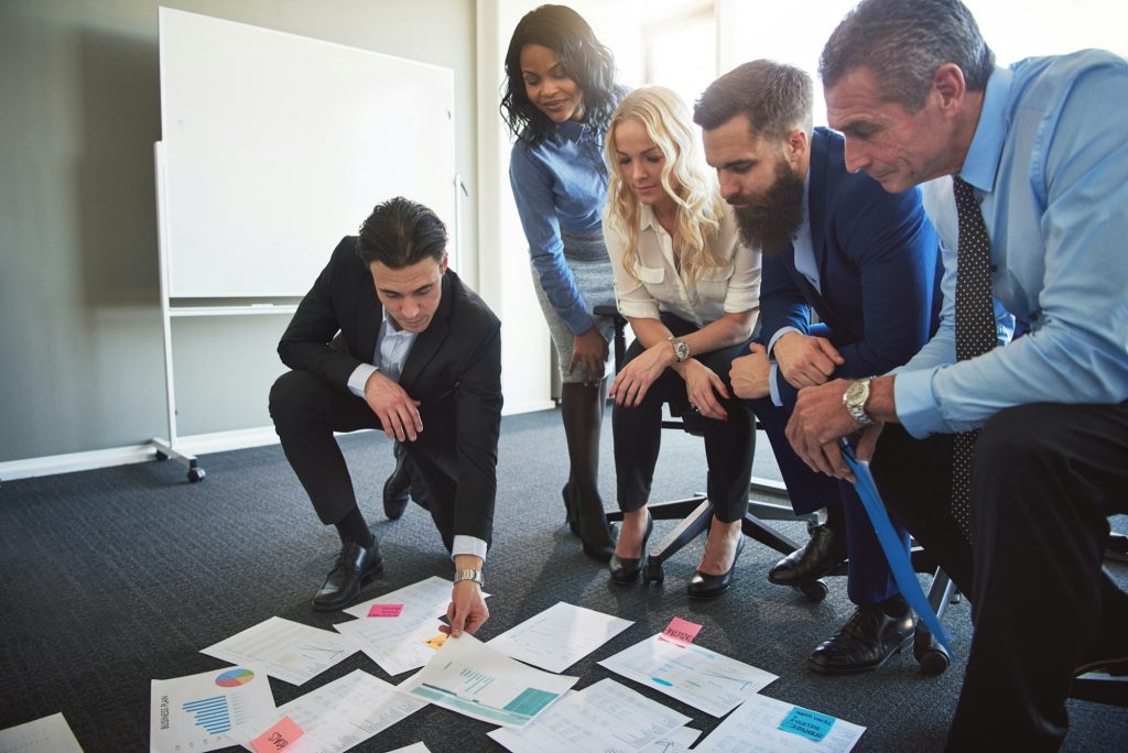 Businesspeople planning and strategizing with documents in an office