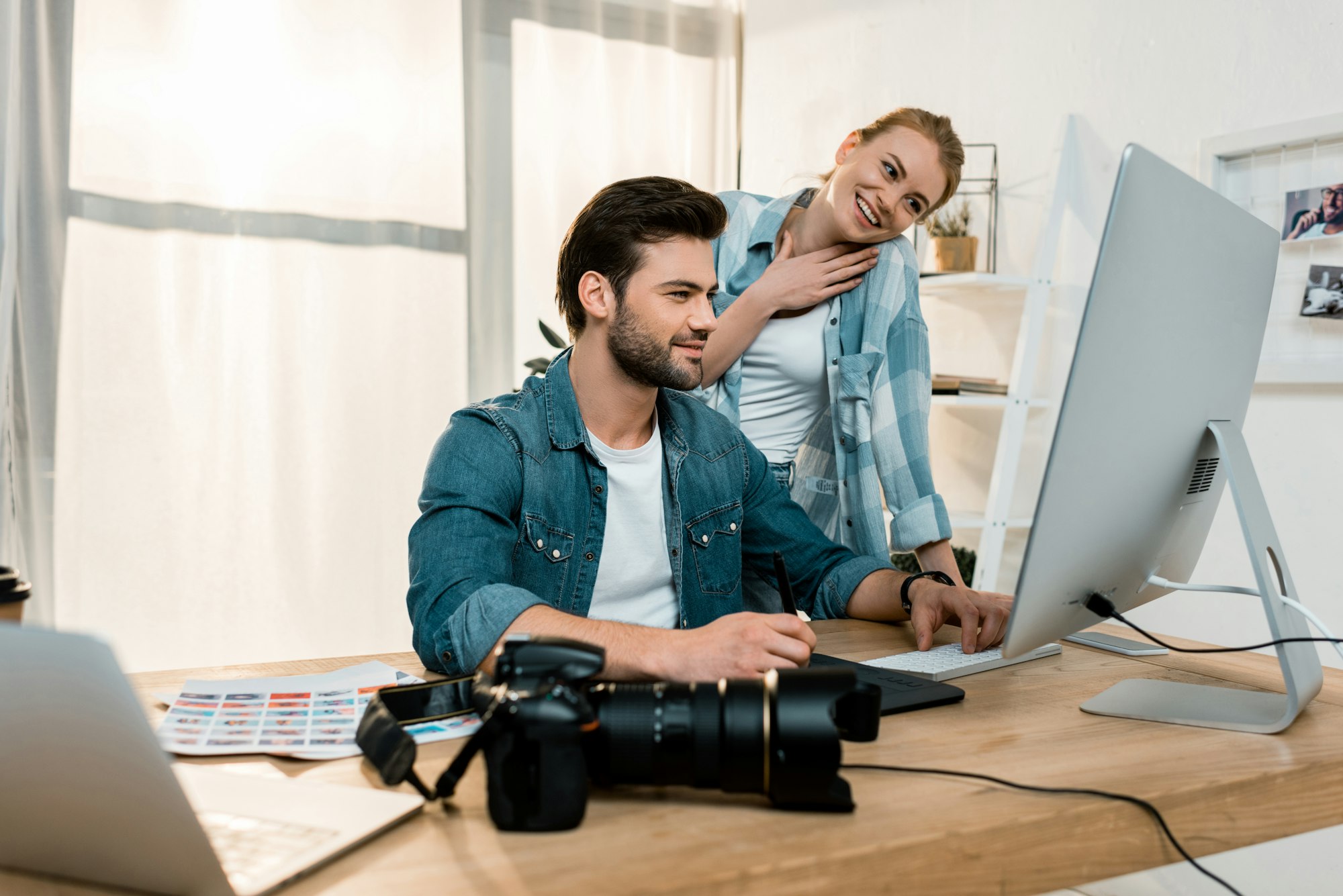 smiling young professional retouchers working together in office